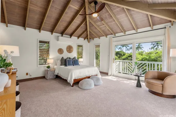 a bedroom with furniture and a large window
