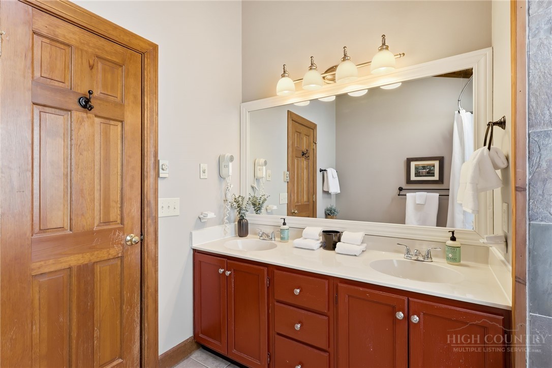 140 Lindale Ridge, Unit 504 Boone, NC 28607 - Photo 9 of 15 a bathroom with a double vanity sink mirror and