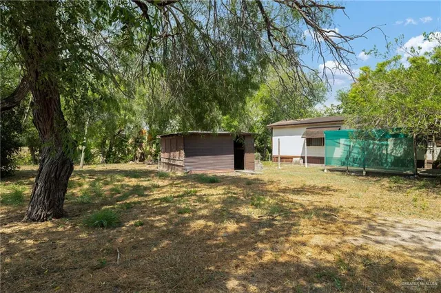 an aerial view of a house with a yard and lake view