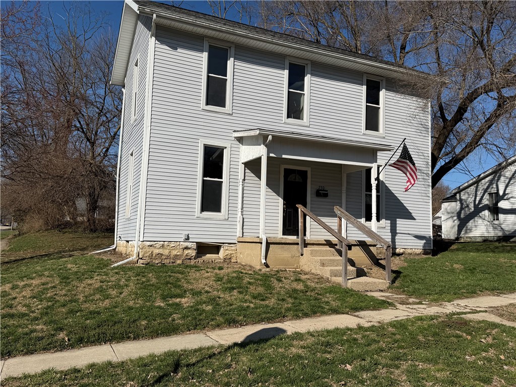 230 West Decatur Street Eaton, OH 45320 - Photo 19 of 22 This charming residence features classic siding and a welcoming porch, nestled amidst mature trees.