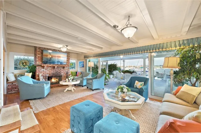 a living room with fireplace furniture and a large window