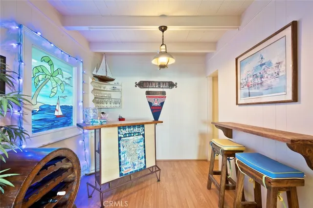 a view of a patio with dining table and chairs with wooden floor and fence