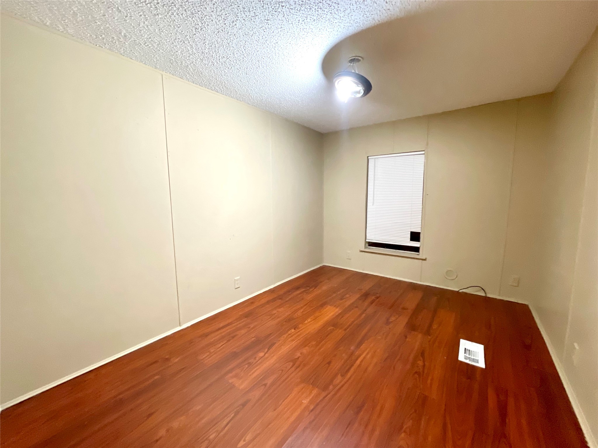 4730 Bayou Lane Rosharon, TX 77583 - Photo 12 of 13 an empty room with wooden floor and windows