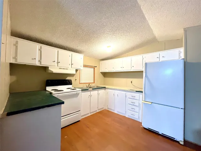 a kitchen with a refrigerator sink and stove