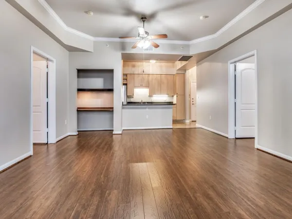 a view of a kitchen with wooden floor a sink and a refrigerator
