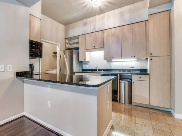 a kitchen with a sink a refrigerator and cabinets