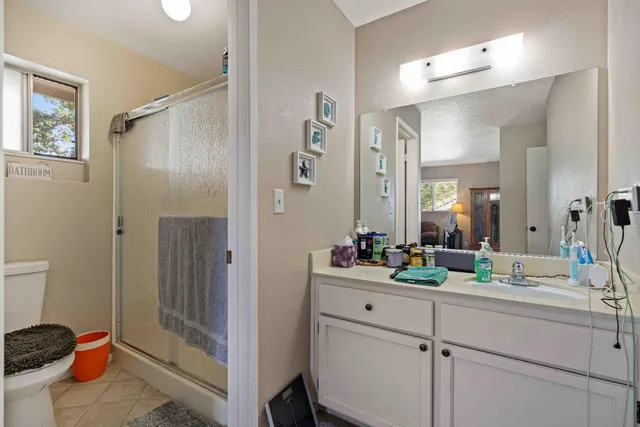 a en suite bathroom with sink mirror and toilet