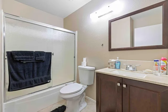a bathroom with a sink vanity mirror and toilet