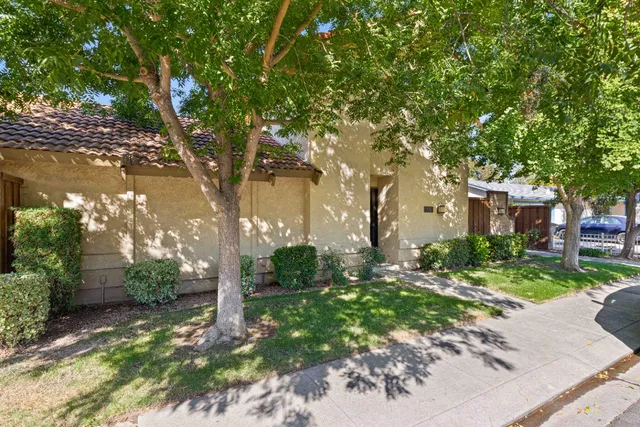 a pathway of a house with a yard