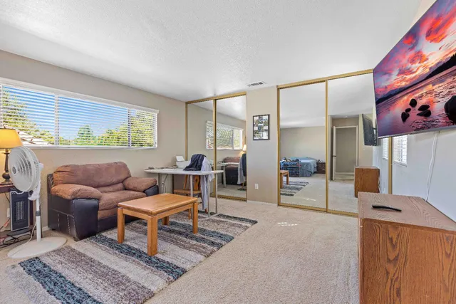 a living room with furniture and a rug