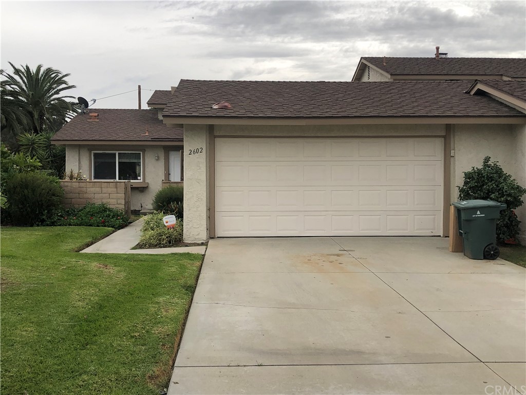 2602 Mangrove Way Riverside, CA 92506 - Photo 1 of 1 a view of a house with a yard plants and large tree