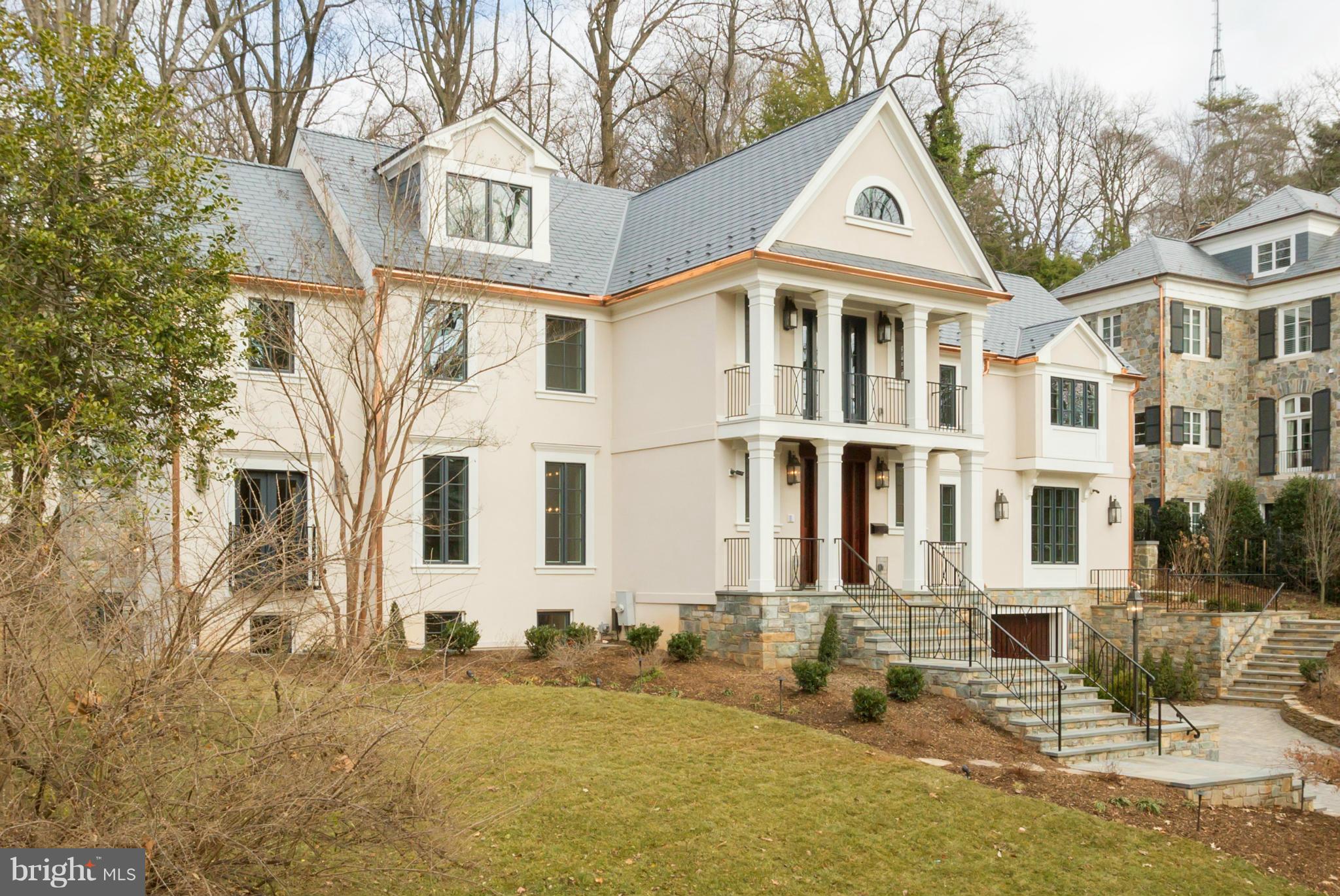 4871 Glenbrook Road Northwest Washington, DC 20016 - Photo 18 of 21 a front view of a residential houses with yard and trees
