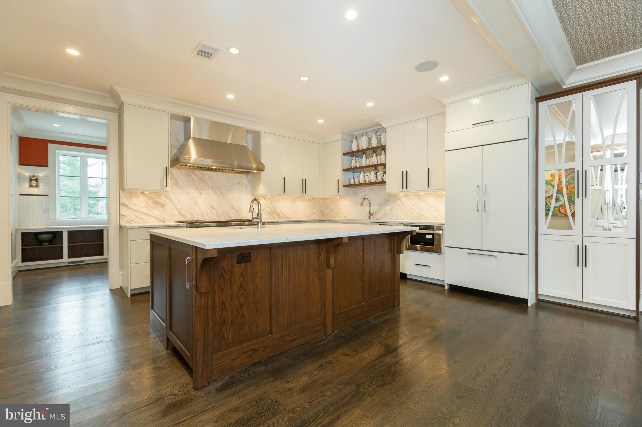 4871 Glenbrook Road Northwest Washington, DC 20016 - Photo 5 of 21 a kitchen with kitchen island a sink appliances and cabinets