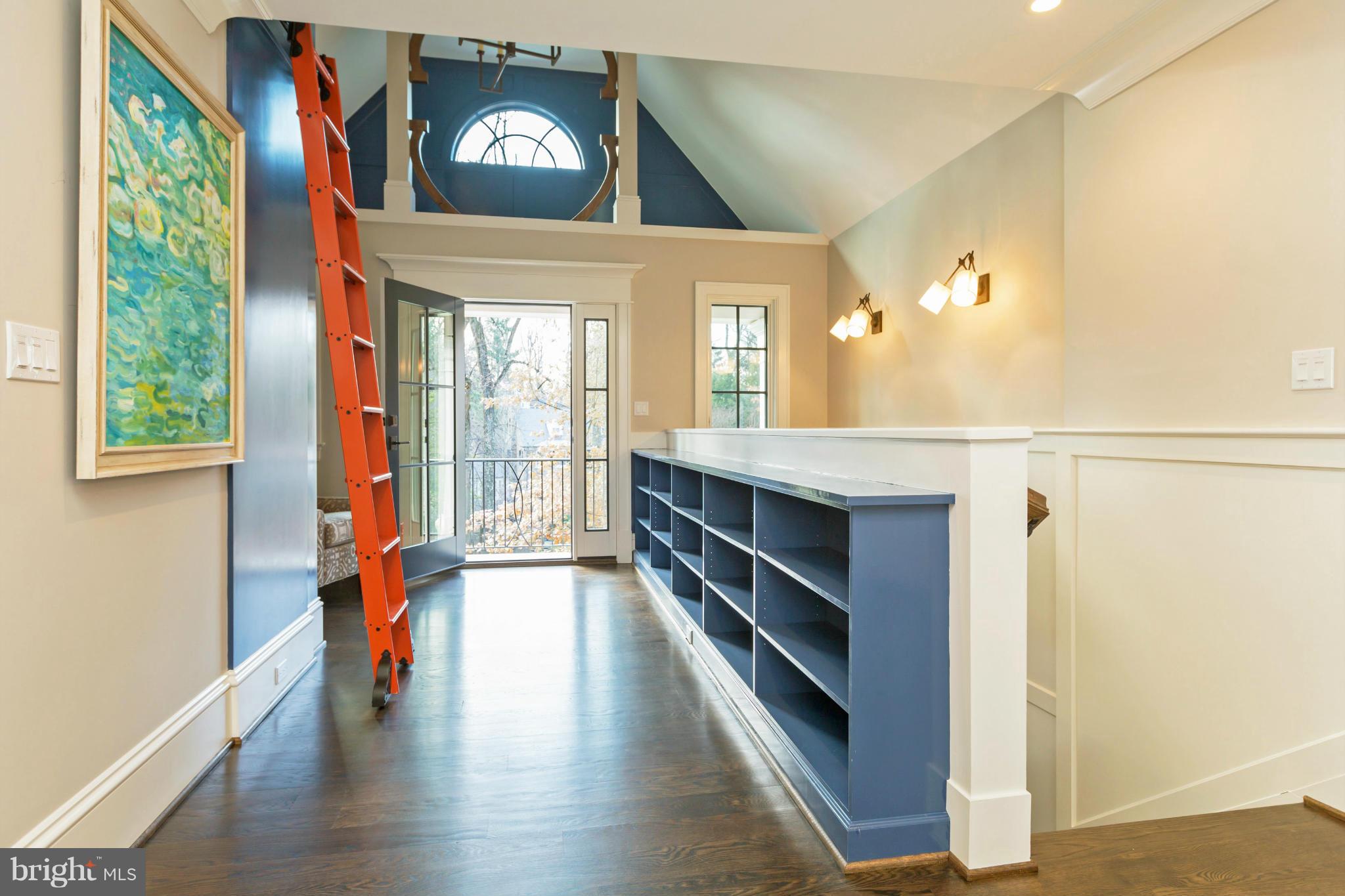 4871 Glenbrook Road Northwest Washington, DC 20016 - Photo 7 of 21 a hallway with a large window and wooden floor