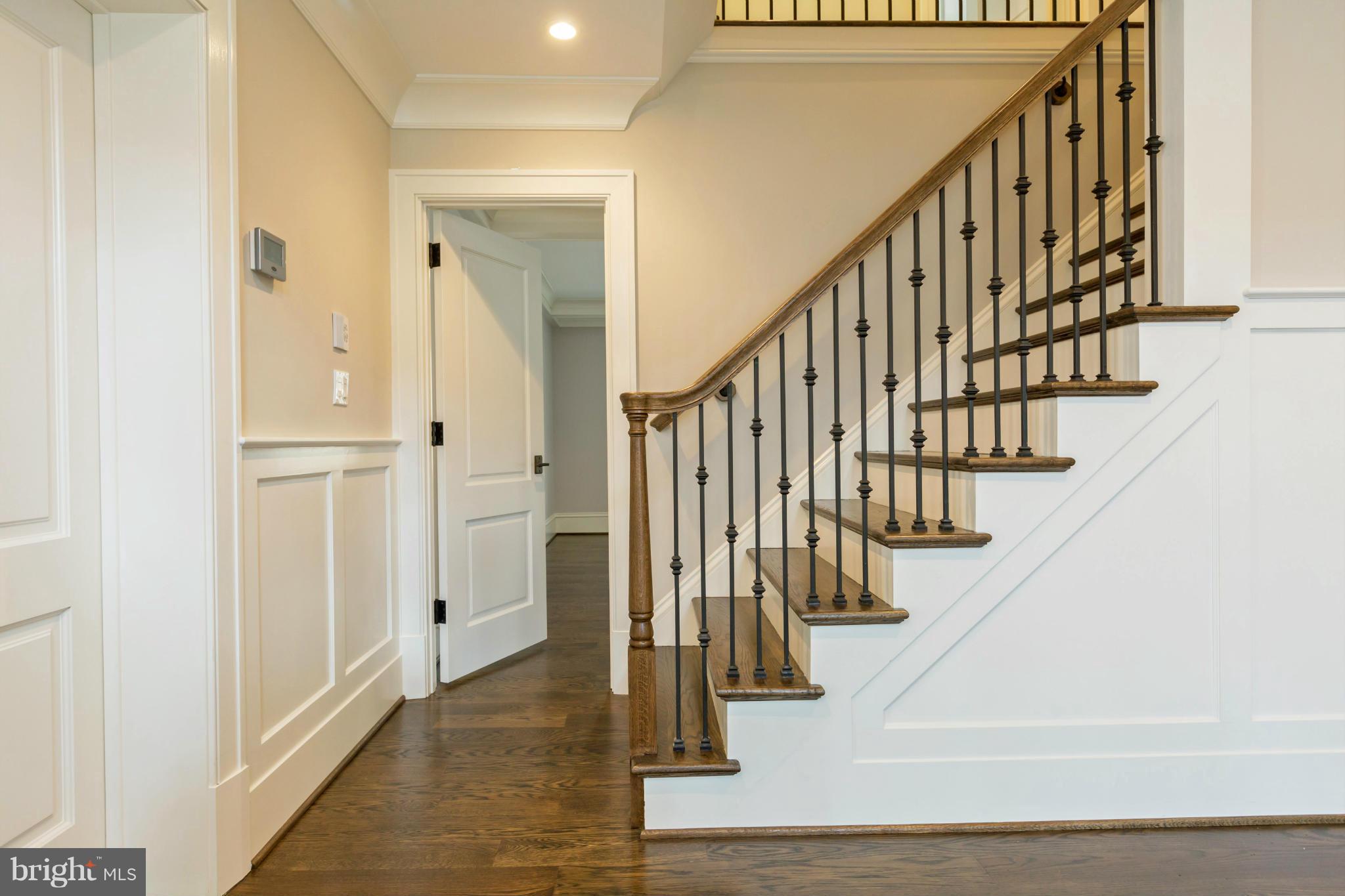 4871 Glenbrook Road Northwest Washington, DC 20016 - Photo 10 of 21 a view of staircase with lots of frames on wall and wooden floor
