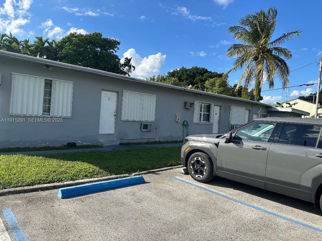 1293 Northeast 109th Street, Unit 3 Miami, FL 33161 - Photo 2 of 10 a front view of a house with a garden