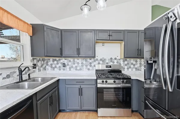 a view of an empty room with a kitchen