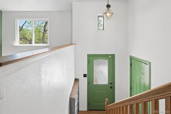 a view of a hallway with windows and entryway