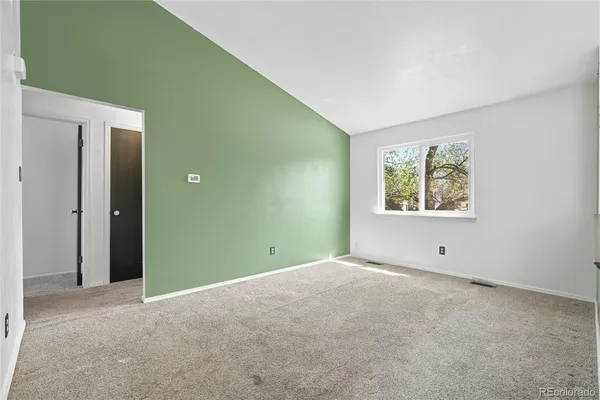 a room with a fan and a window