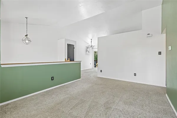 an empty room with window and closet area