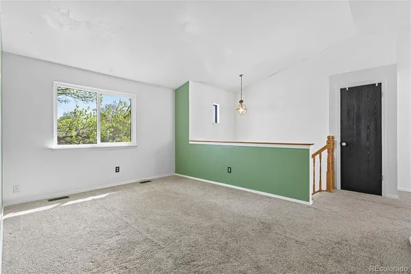 a view of an empty room with a window