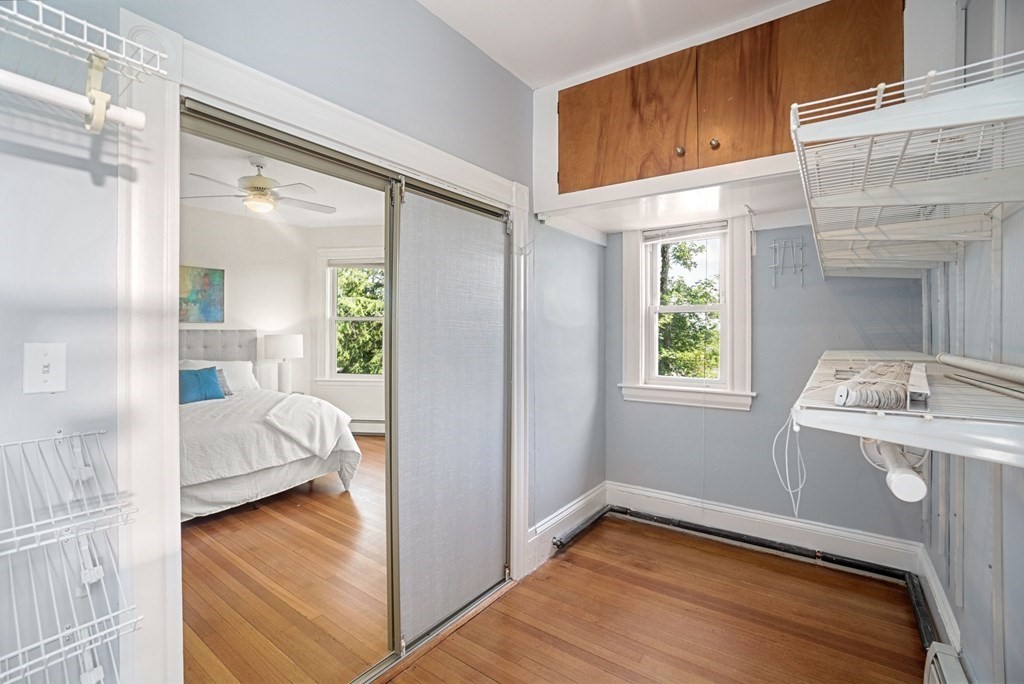 90 Robbins Road, Unit 2 Arlington, MA 02476 - Photo 11 of 32 a view of a bedroom with a bed and wooden floor