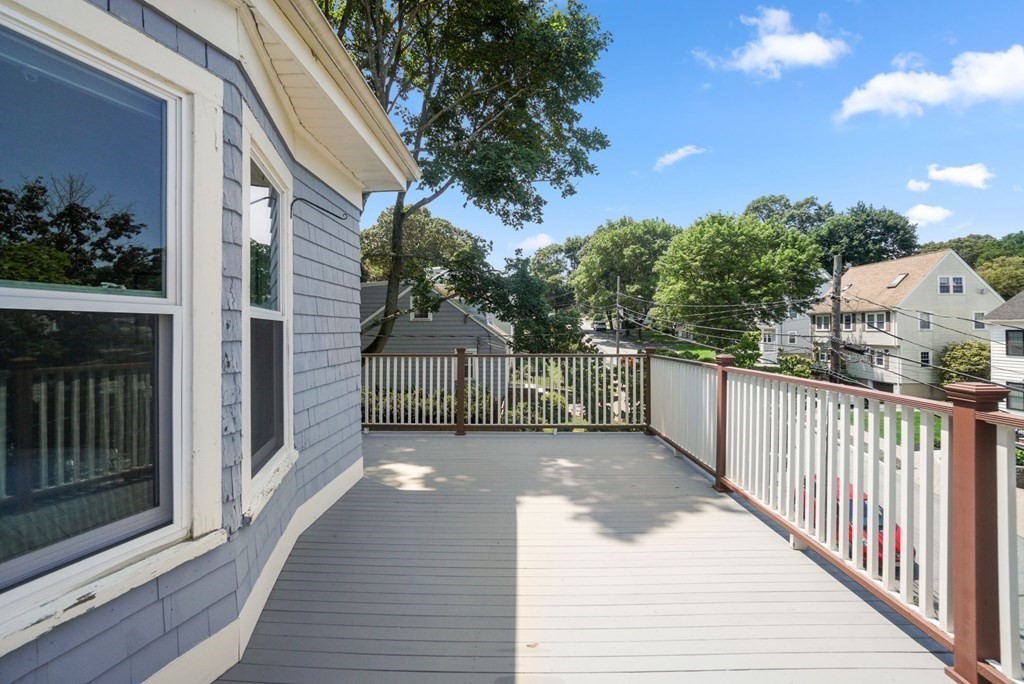 90 Robbins Road, Unit 2 Arlington, MA 02476 - Photo 24 of 32 a view of a porch with wooden floor and fence