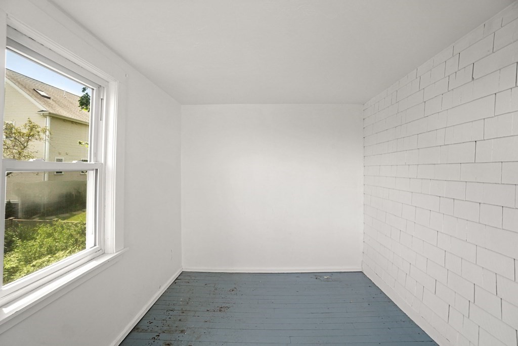 90 Robbins Road, Unit 2 Arlington, MA 02476 - Photo 28 of 32 a view of a small space with wooden floor and a window