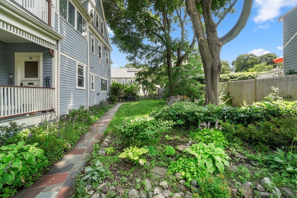 90 Robbins Road, Unit 2 Arlington, MA 02476 - Photo 30 of 32 a view of a house with a yard and plants