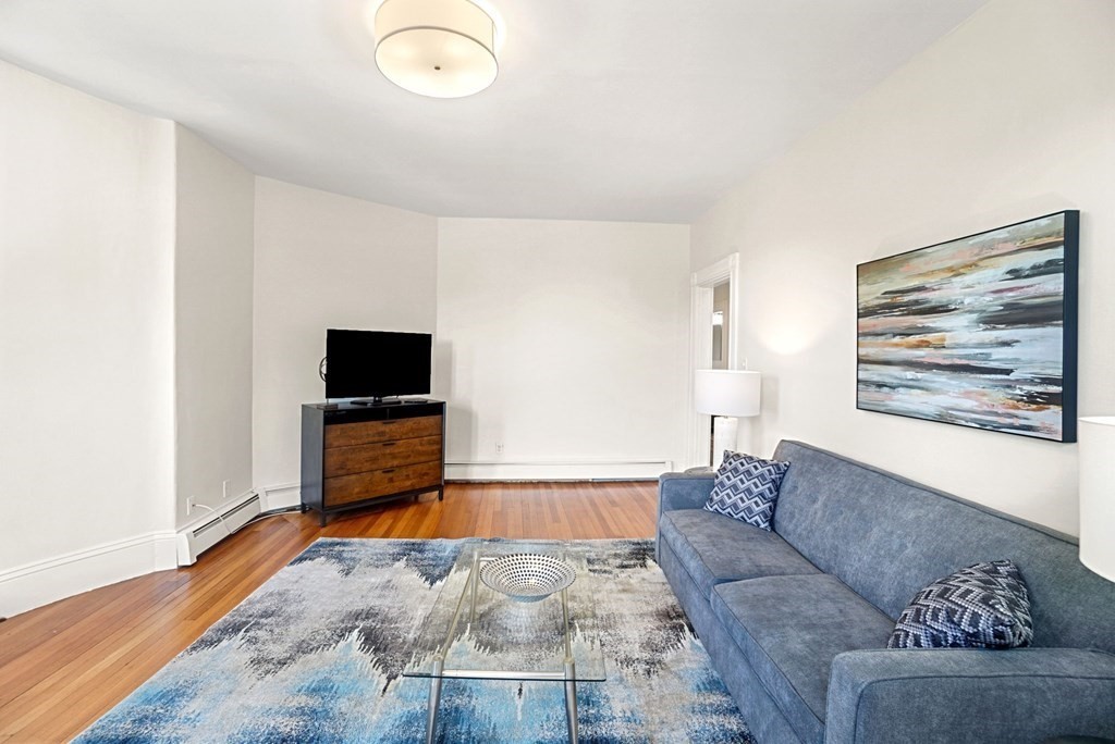 90 Robbins Road, Unit 2 Arlington, MA 02476 - Photo 3 of 32 a living room with furniture and a flat screen tv