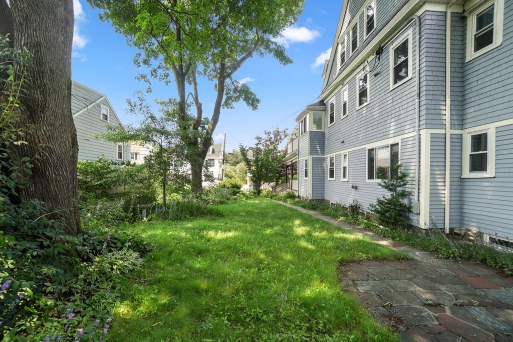 90 Robbins Road, Unit 2 Arlington, MA 02476 - Photo 31 of 32 a view of a big yard with plants and large trees