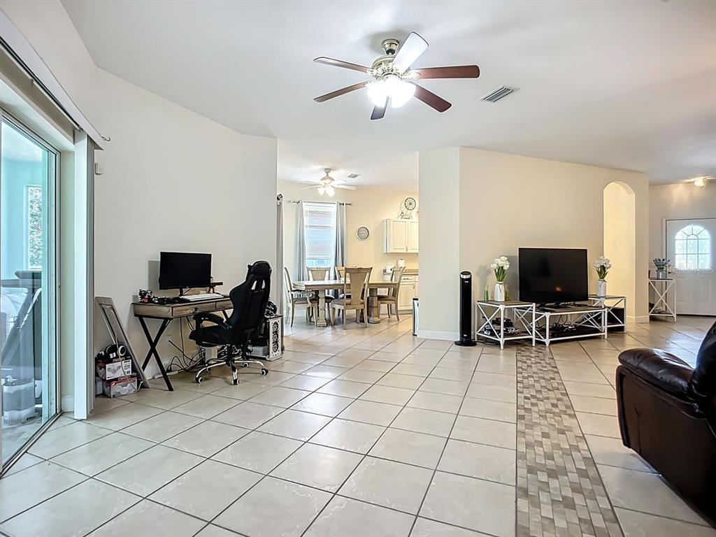 394 Sunset Road Rotonda West, FL 33947 - Photo 12 of 41 a living room with furniture and a flat screen tv
