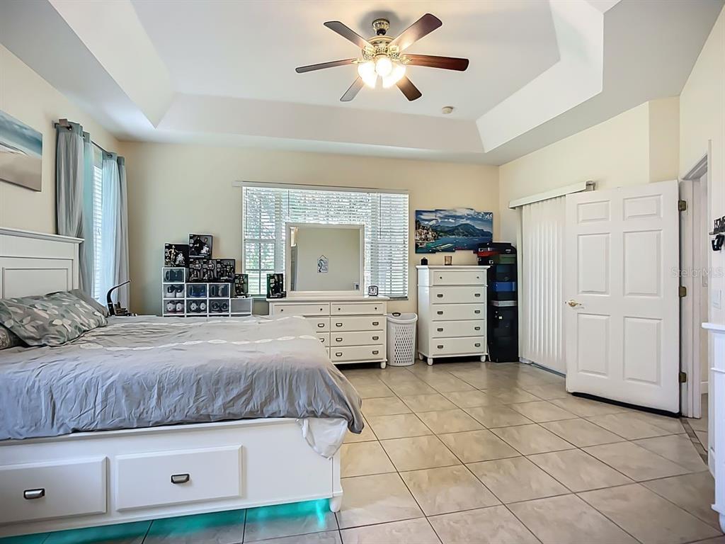 394 Sunset Road Rotonda West, FL 33947 - Photo 17 of 41 a bedroom with a bed and a chandelier