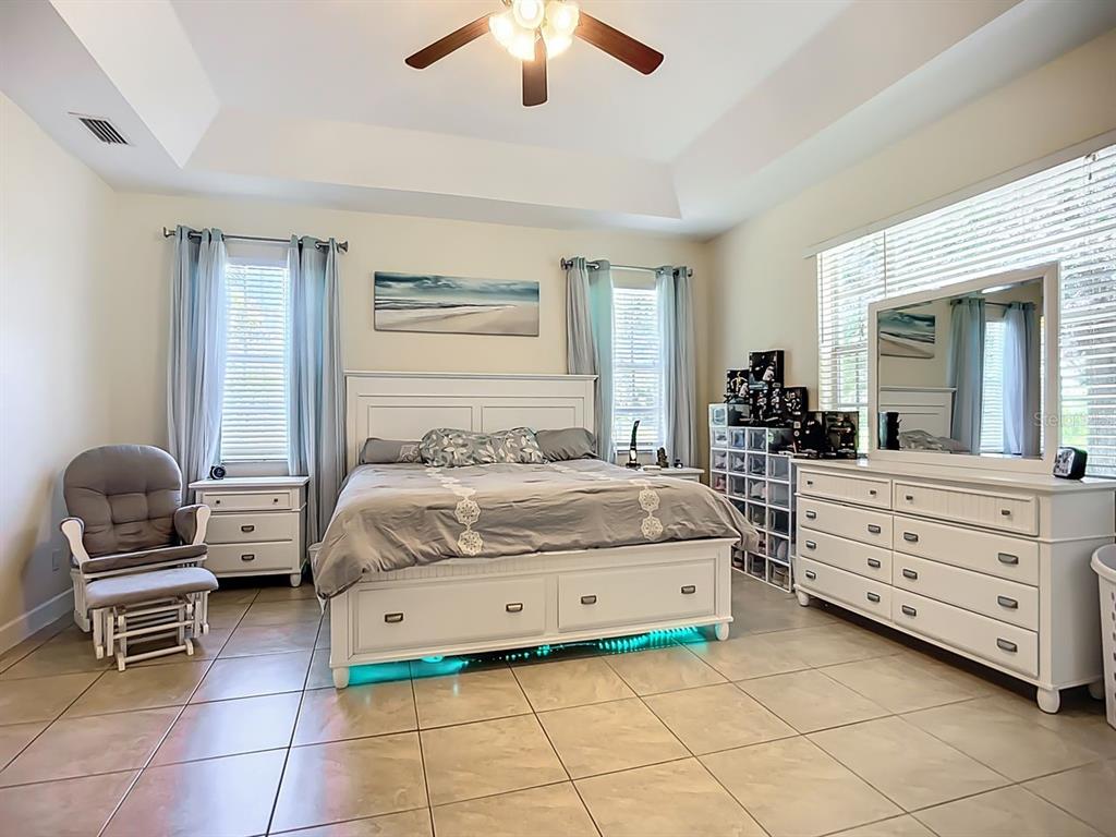 394 Sunset Road Rotonda West, FL 33947 - Photo 18 of 41 a bedroom with a bed and a chair