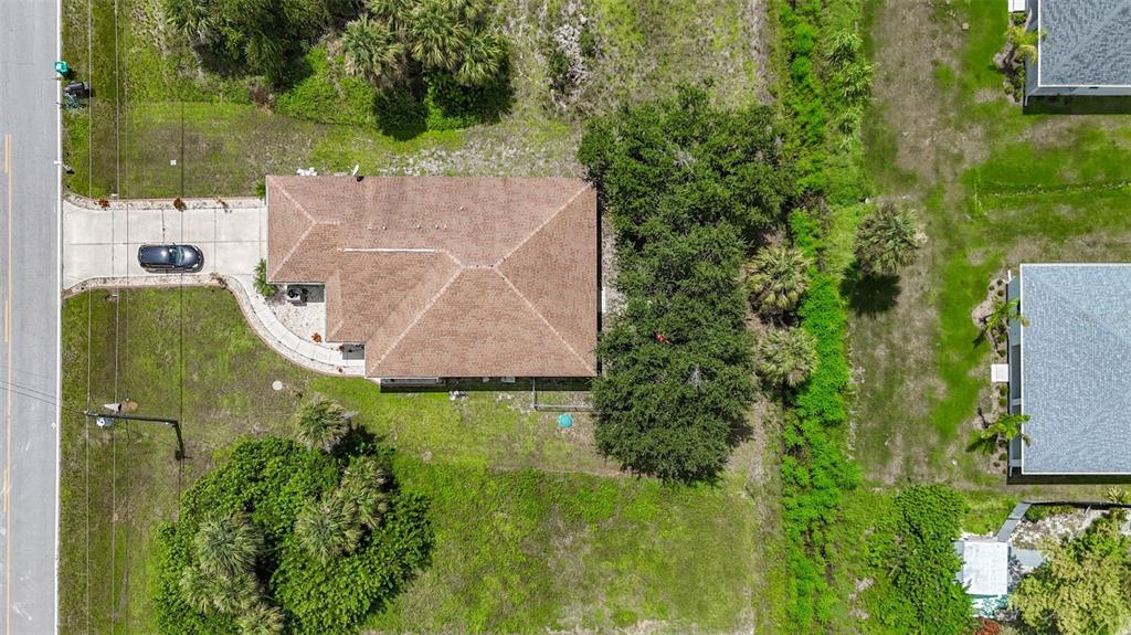 394 Sunset Road Rotonda West, FL 33947 - Photo 2 of 41 an aerial view of a house with a yard