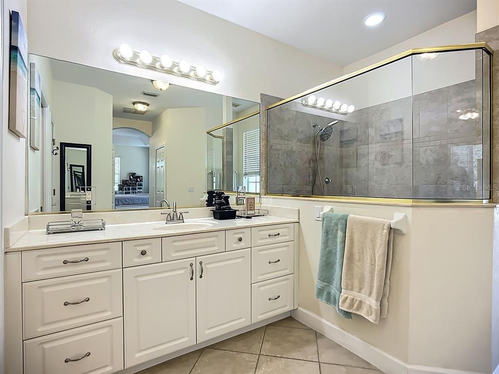 394 Sunset Road Rotonda West, FL 33947 - Photo 22 of 41 a bathroom with a double vanity sink mirror and