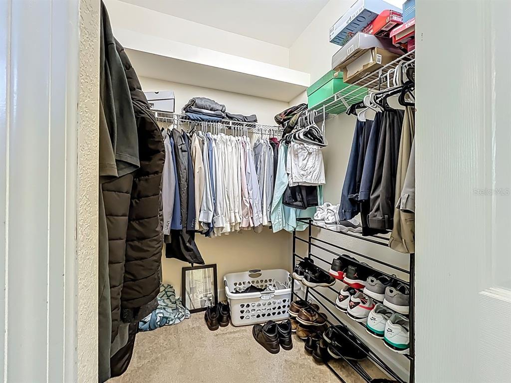 394 Sunset Road Rotonda West, FL 33947 - Photo 25 of 41 a view of walk in closet with clothes and shoes