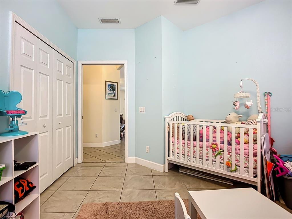 394 Sunset Road Rotonda West, FL 33947 - Photo 26 of 41 a bedroom with a bed and a window