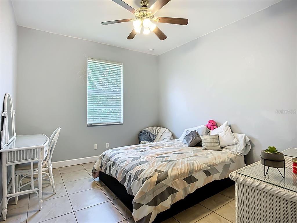 394 Sunset Road Rotonda West, FL 33947 - Photo 28 of 41 a bedroom with a bed and a table