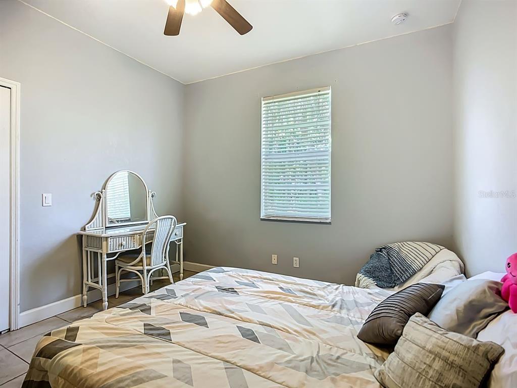 394 Sunset Road Rotonda West, FL 33947 - Photo 29 of 41 a bedroom with a bed and a window