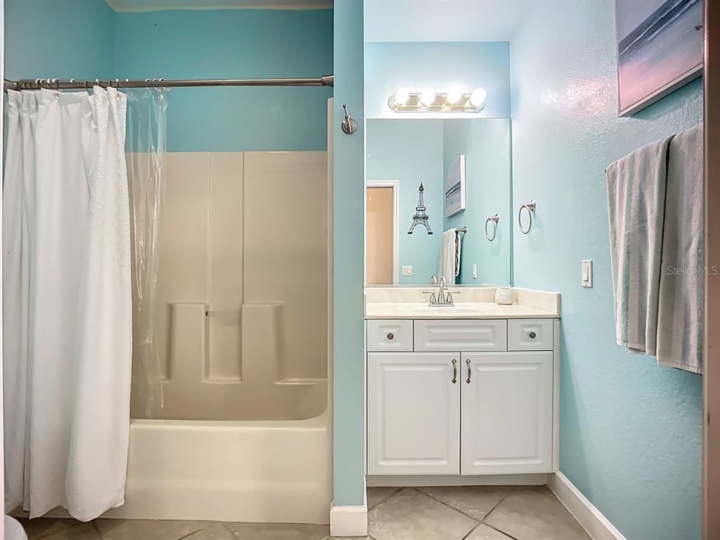 394 Sunset Road Rotonda West, FL 33947 - Photo 30 of 41 a bathroom with a double vanity sink and a mirror