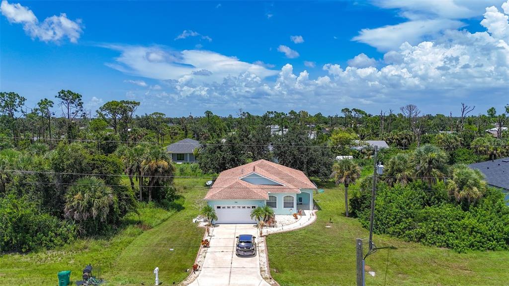 394 Sunset Road Rotonda West, FL 33947 - Photo 3 of 41 a view of a house with a yard and lake view