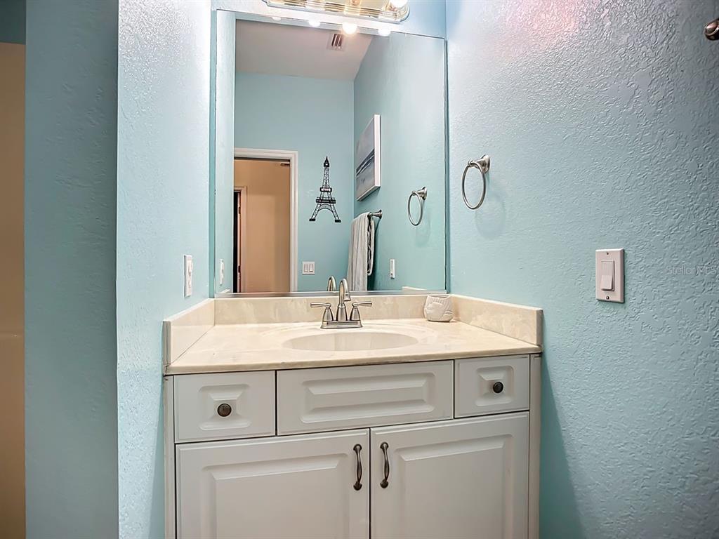 394 Sunset Road Rotonda West, FL 33947 - Photo 31 of 41 a bathroom with a sink and a mirror