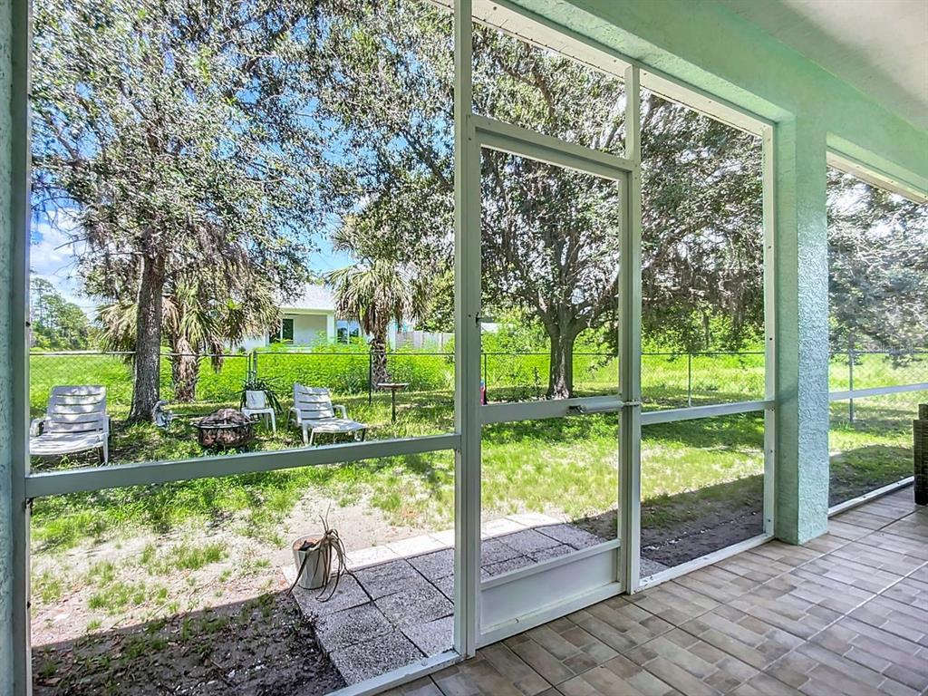 394 Sunset Road Rotonda West, FL 33947 - Photo 35 of 41 a view of backyard with large trees and plants