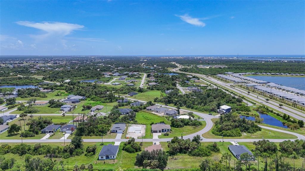 394 Sunset Road Rotonda West, FL 33947 - Photo 40 of 41 an aerial view of residential houses with outdoor space and trees