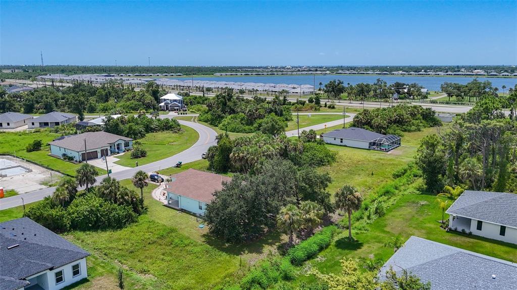 394 Sunset Road Rotonda West, FL 33947 - Photo 5 of 41 an aerial view of a houses with a yard and lake view