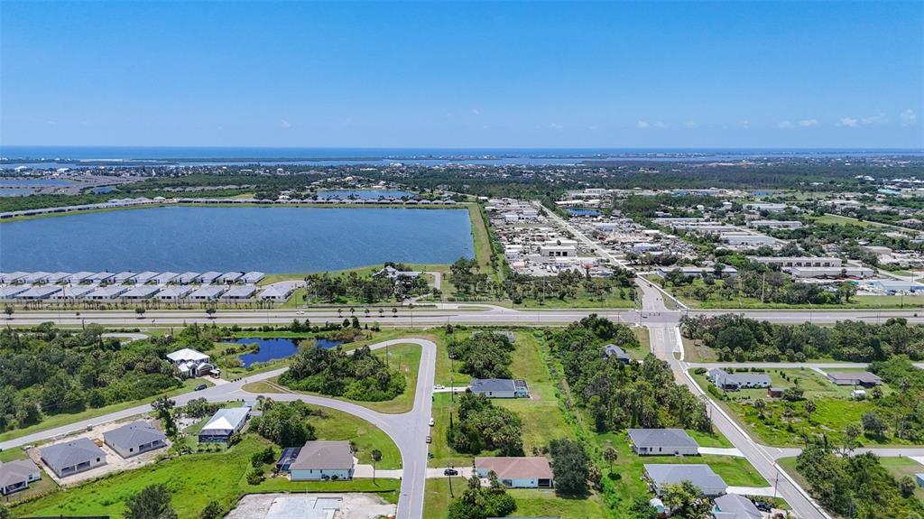 394 Sunset Road Rotonda West, FL 33947 - Photo 6 of 41 an aerial view of a city with lots of residential buildings ocean and mountain view in back