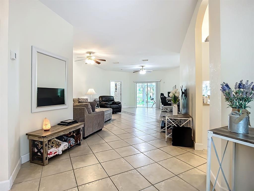 394 Sunset Road Rotonda West, FL 33947 - Photo 9 of 41 a living room with furniture and a flat screen tv