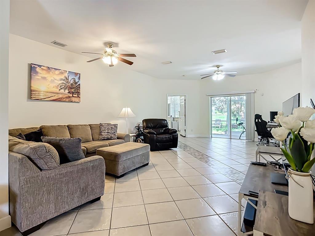 394 Sunset Road Rotonda West, FL 33947 - Photo 10 of 41 a living room with furniture and a chandelier