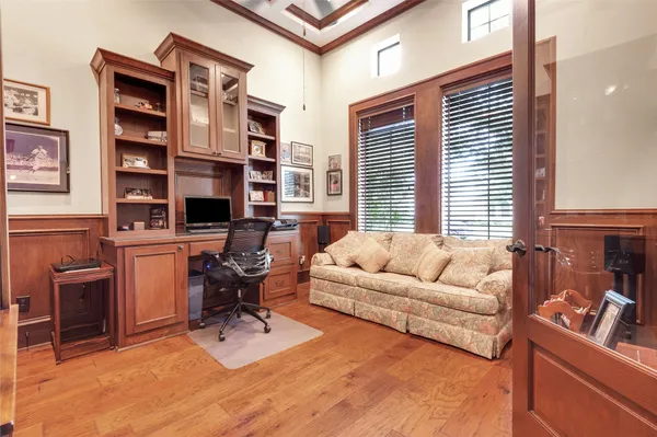 a dining room with furniture a fireplace and a floor to ceiling window